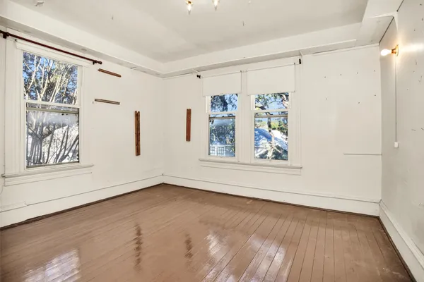wooden floor in an empty room with a window