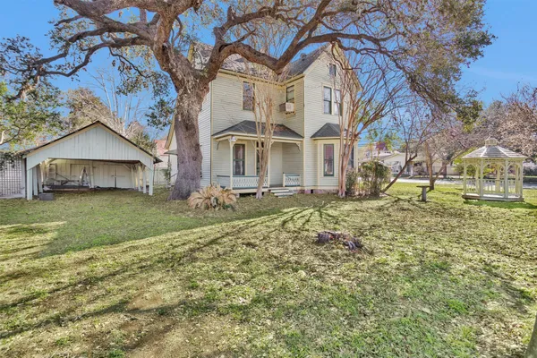 an aerial view of a house with a yard
