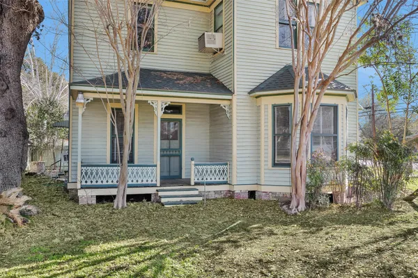 an aerial view of a house with a yard