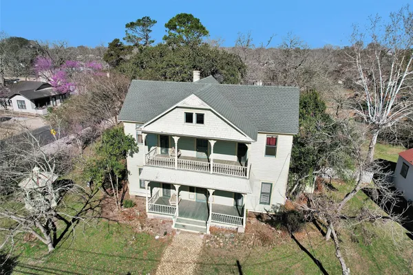 an aerial view of residential houses with outdoor space
