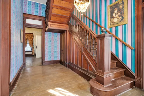 a view of an entryway with wooden floor and stairs