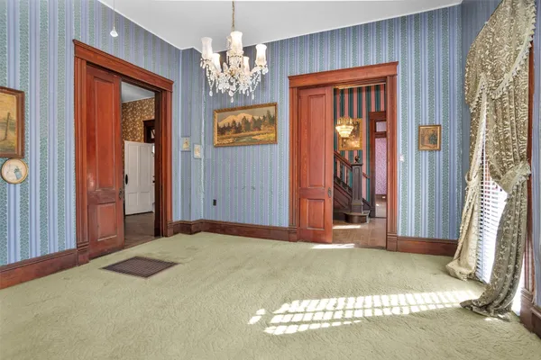 a view of a room with large windows and cabinet