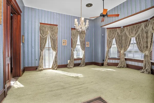a view of an empty room with a fireplace and a window