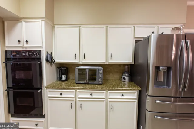 a dining room with furniture a chandelier and wooden floor