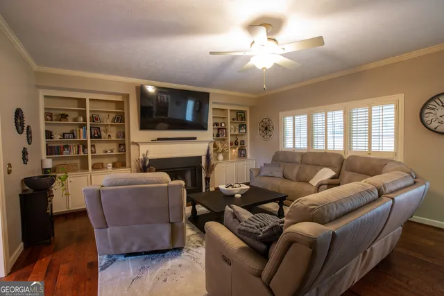 a bedroom with furniture and a mirror