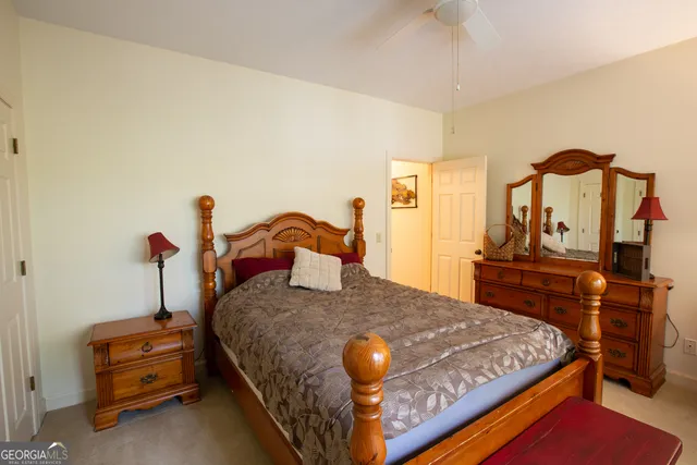 a bathroom with a granite countertop double vanity sink and a mirror