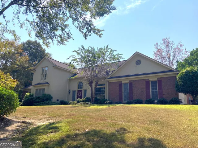 a front view of house with yard and green space