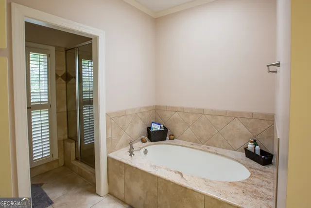 a bedroom with bed and a chandelier