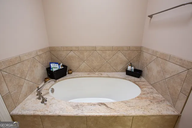 a view of a hallway with wooden floor and closet