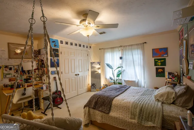 a view of a house with a yard chairs and table in a patio