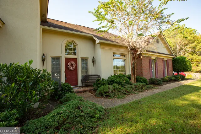 a front view of a house with garden