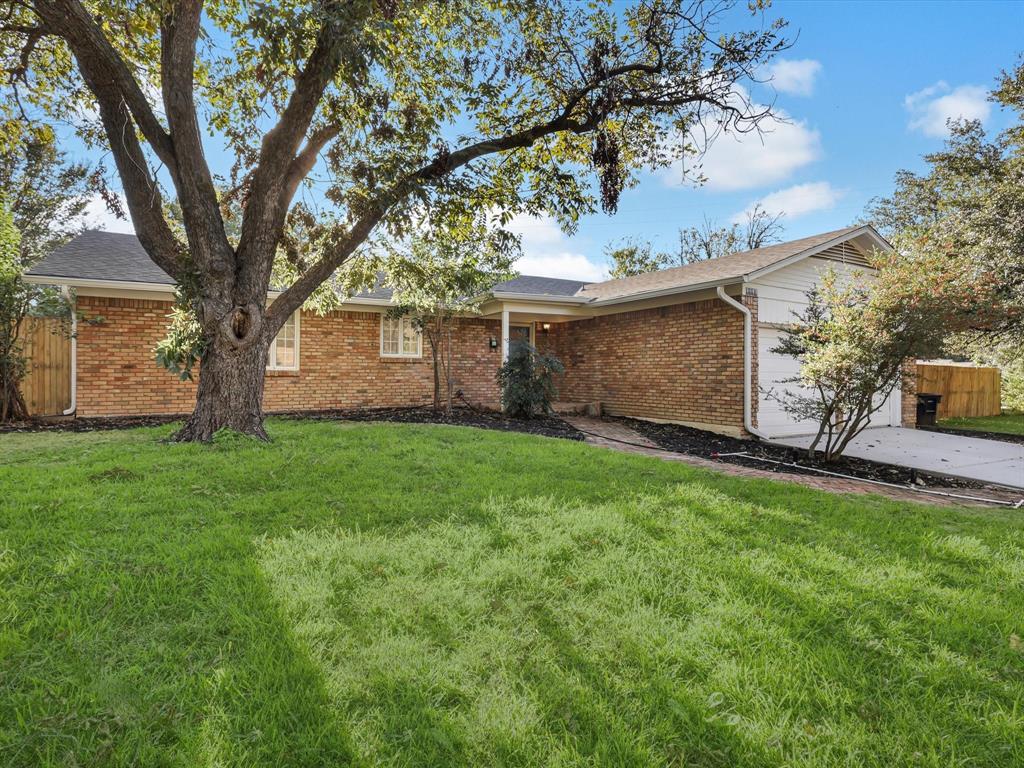 a view of house with backyard