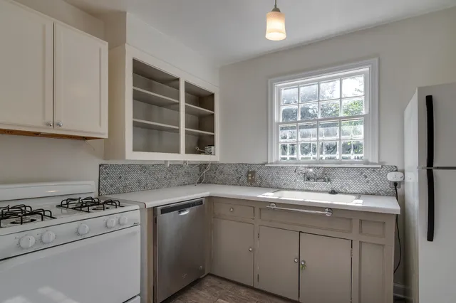 a kitchen with a sink stove and cabinets