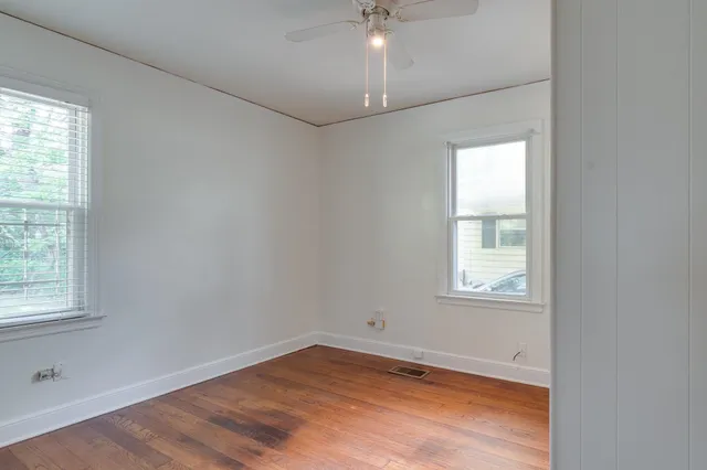 wooden floor in an empty room with a window
