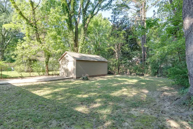 a backyard of a house with table and chairs