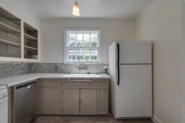a kitchen with a sink and a refrigerator
