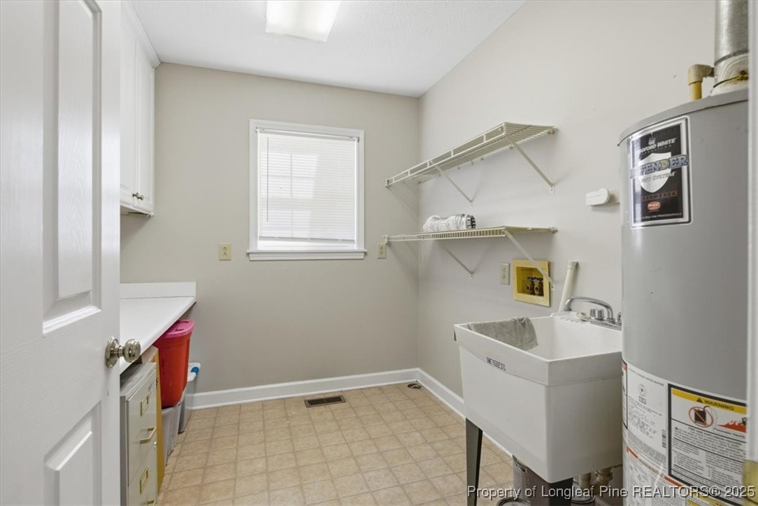 1594 Carroll Store Road Autryville, NC 28318 - Photo 16 of 36 a bathroom with a sink vanity and tub