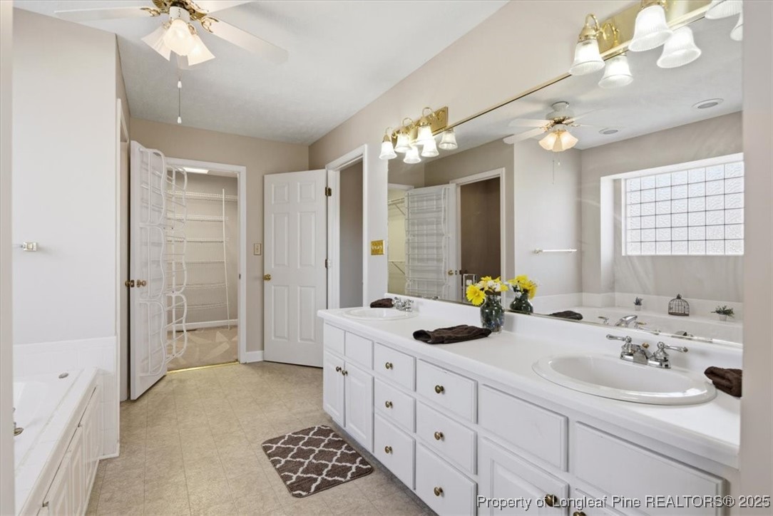 1594 Carroll Store Road Autryville, NC 28318 - Photo 20 of 36 a spacious en suite bathroom with a double vanity sink mirror and shower
