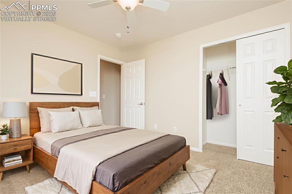 4815 Harrier Ridge Drive Colorado Springs, CO 80916 - Photo 15 of 33 Bedroom featuring light colored carpet, a ceiling fan, and a closet Virtually Staged