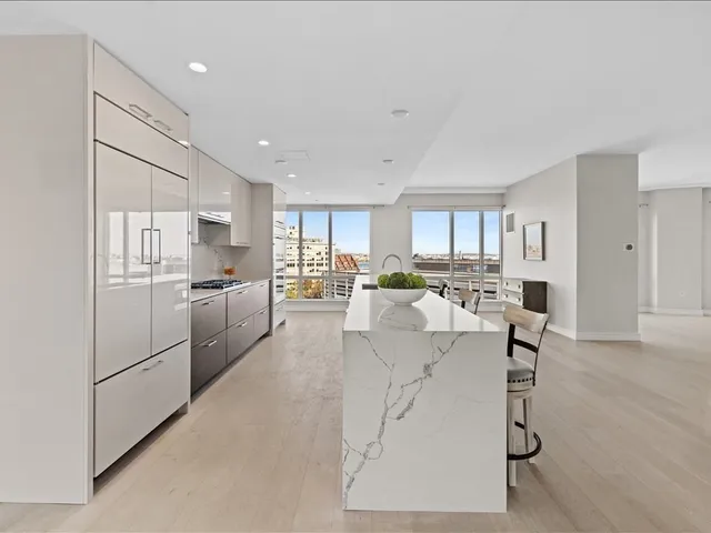a living room with furniture and kitchen view