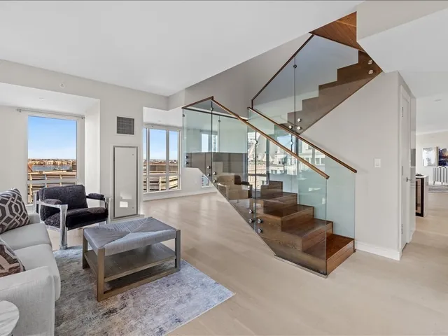 a living room with furniture and stairs