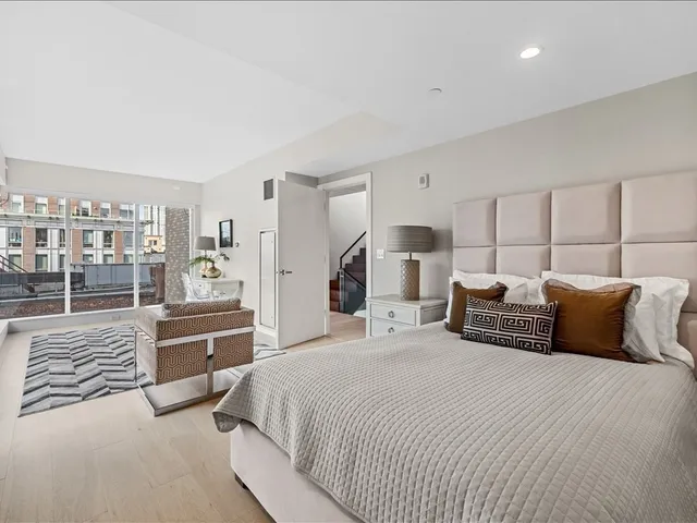 a bedroom with a large bed and a walk in closet