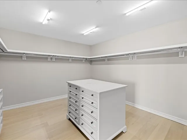 a bathroom with a double vanity sink mirror and bathtub