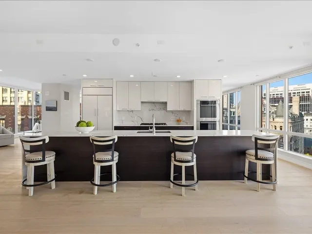 a kitchen with a table chairs sink and cabinets
