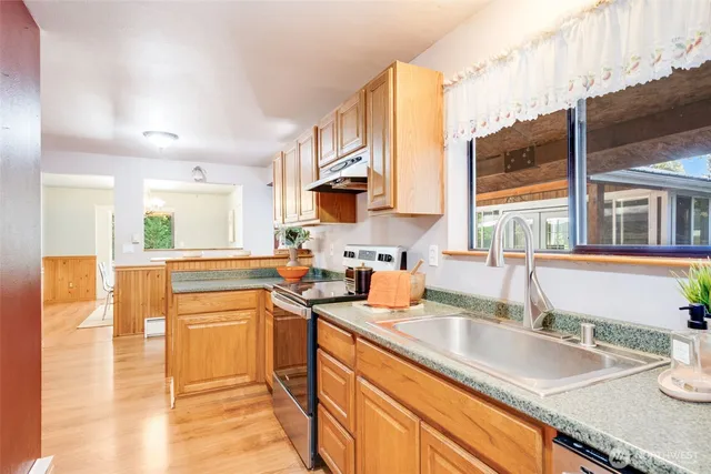 a kitchen with a sink a counter top space and cabinets