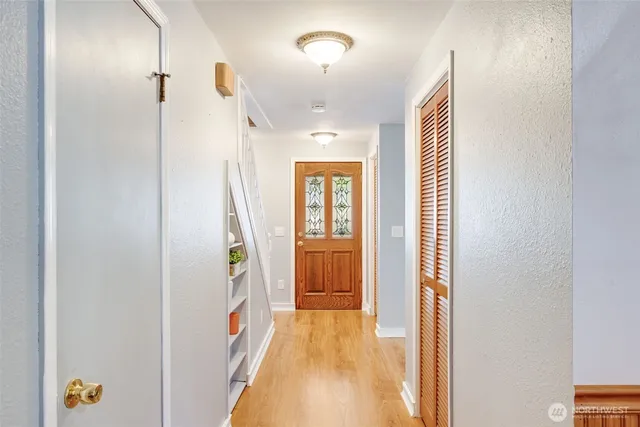 a view of an entryway with wooden floor