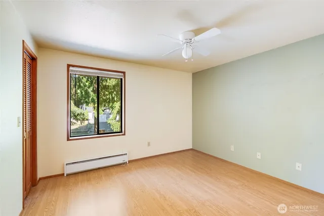 an empty room with windows and closet