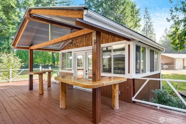 a view of patio with table and chairs and wooden floor