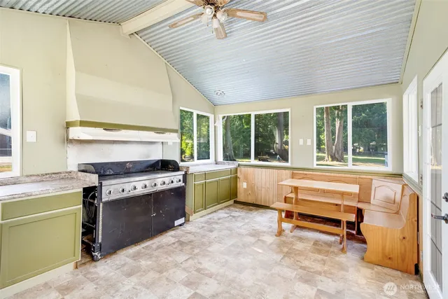 a kitchen with a stove and a window
