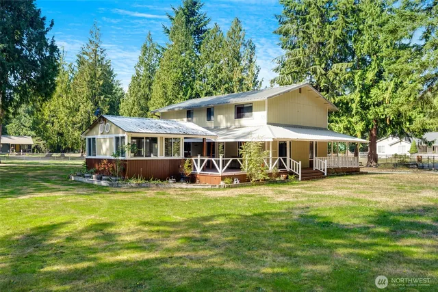 a view of a house with backyard porch and sitting area