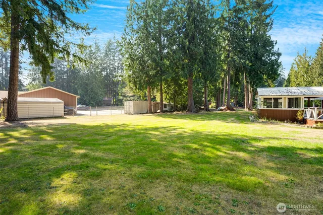 a swimming pool with outdoor seating and yard