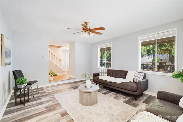 a living room with furniture and a potted plant