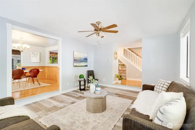a living room with furniture and a potted plant
