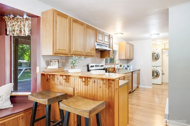 a kitchen with stainless steel appliances kitchen island granite countertop a sink and cabinets