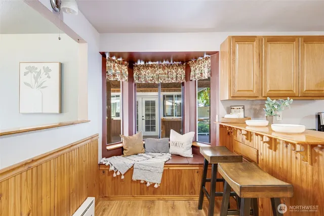 a living room with furniture a window and a kitchen view