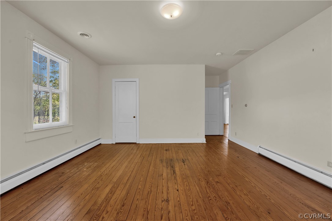 20011 Genito Road Moseley, VA 23120 - Photo 21 of 50 a view of an empty room with wooden floor and a window