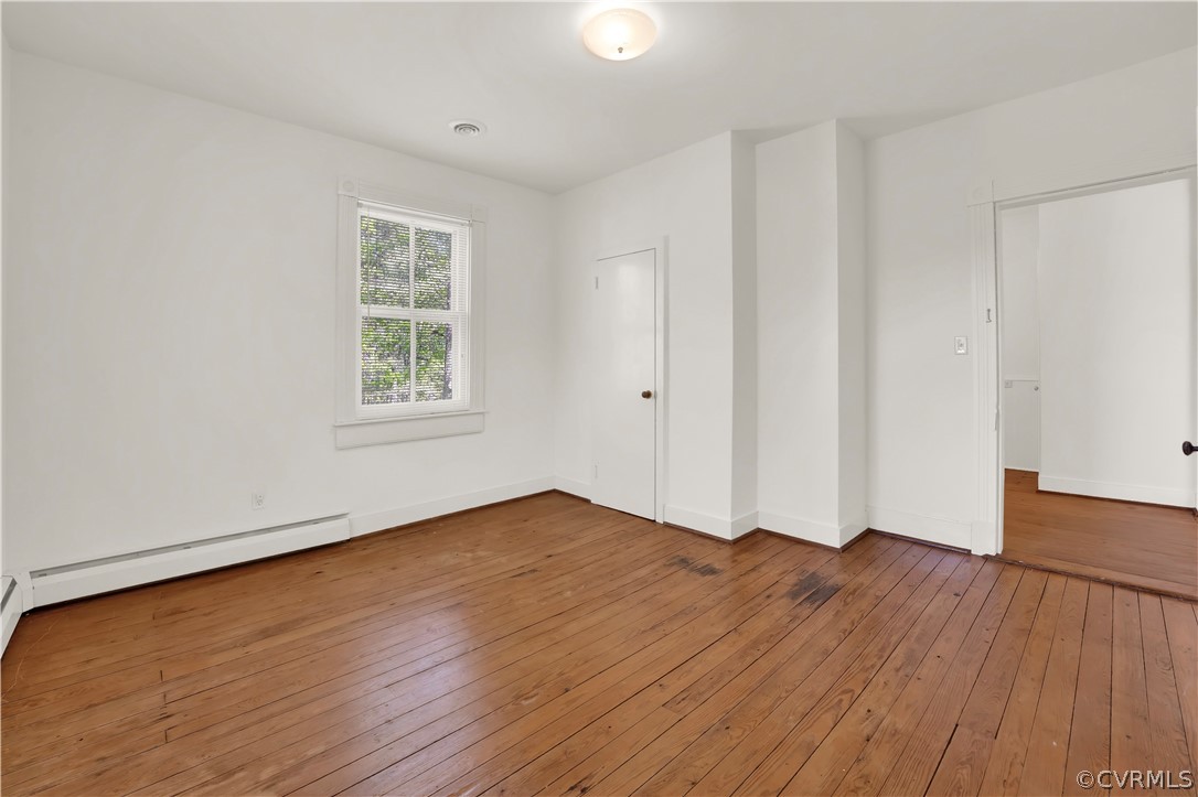 20011 Genito Road Moseley, VA 23120 - Photo 24 of 50 a view of an empty room with wooden floor and a window