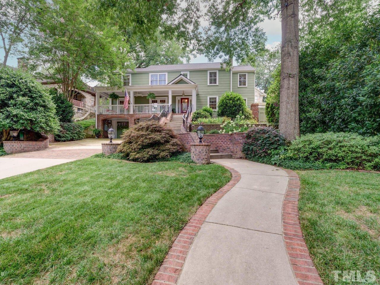 2504 Kenmore Drive Raleigh, NC 27608 - Photo 1 of 3 a front view of a house with a garden and trees