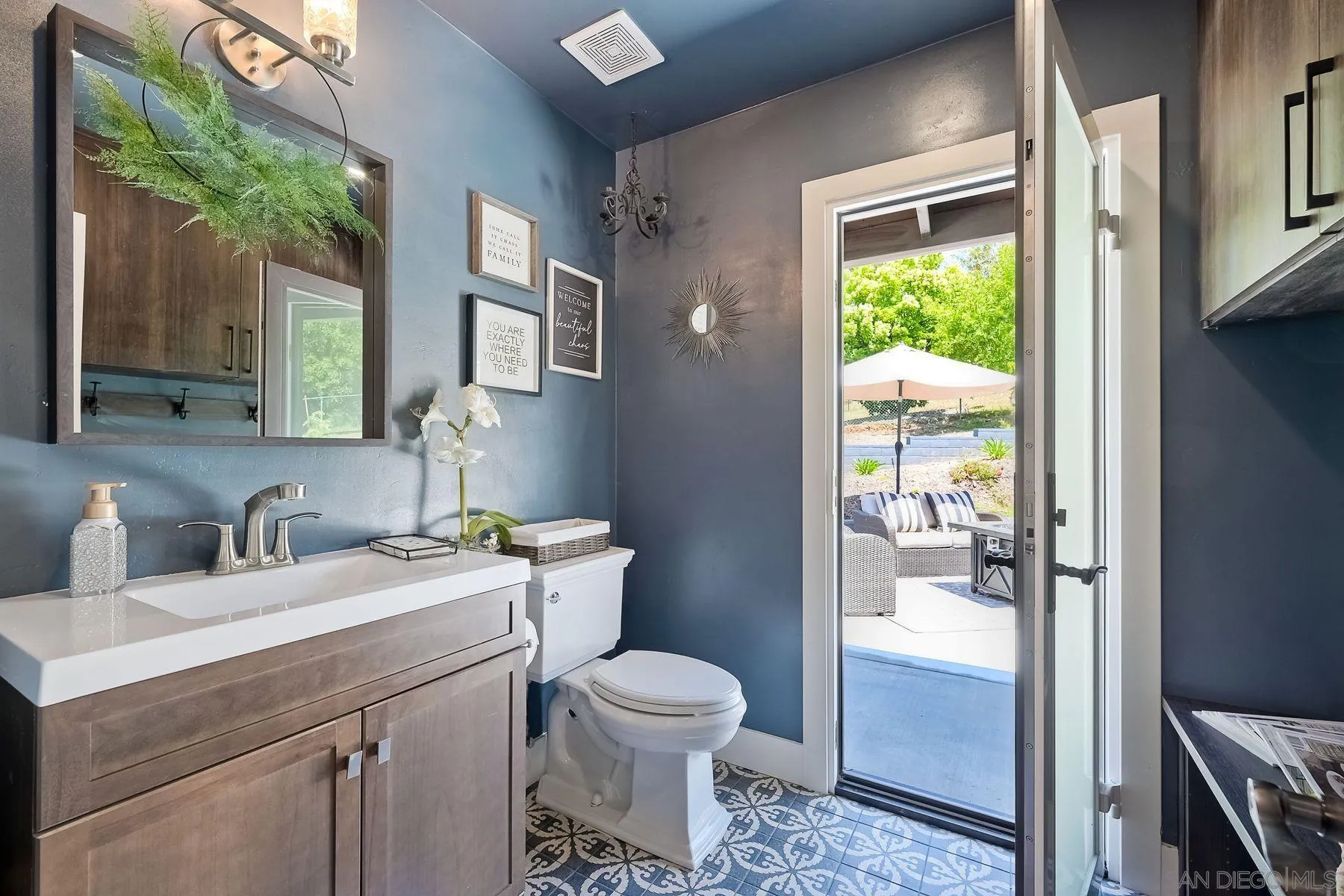 660 Via Rancho Parkway Escondido, CA 92029 - Photo 18 of 37 a bathroom with a toilet sink and a mirror