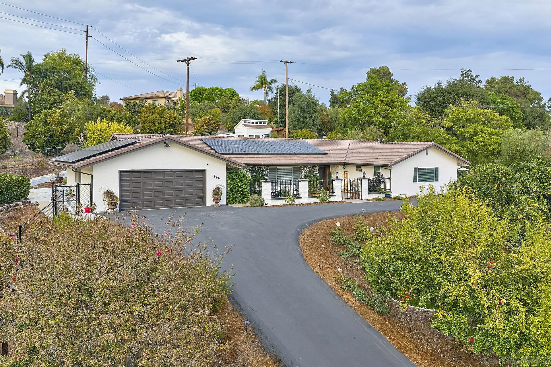 660 Via Rancho Parkway Escondido, CA 92029 - Photo 27 of 37 a front view of a house with a garden