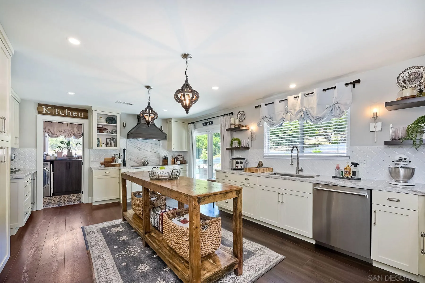 660 Via Rancho Parkway Escondido, CA 92029 - Photo 7 of 37 a kitchen with a sink cabinets and wooden floor