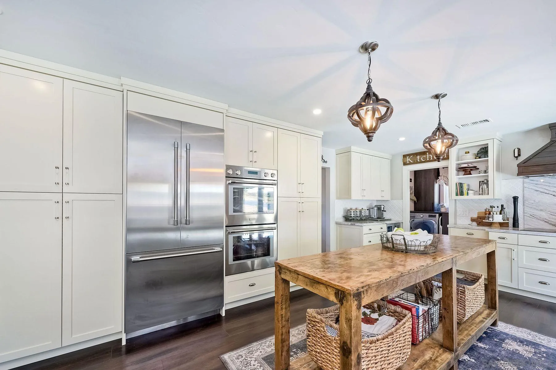 660 Via Rancho Parkway Escondido, CA 92029 - Photo 9 of 37 a kitchen with stainless steel appliances kitchen island granite countertop a refrigerator a sink dishwasher a stove and a dining table with wooden floor