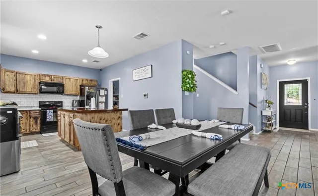 a view of a dining room with furniture and wooden floor
