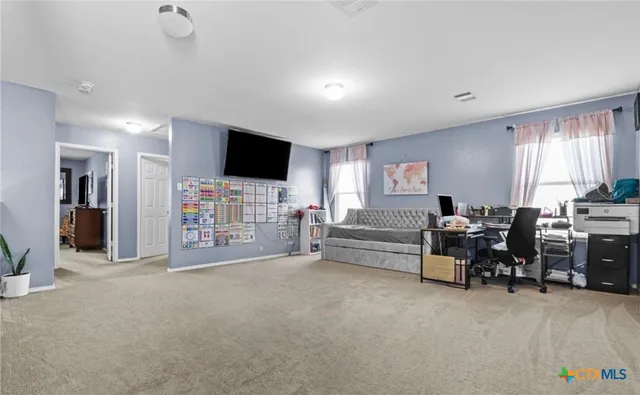a view of a livingroom with furniture and a flat screen tv