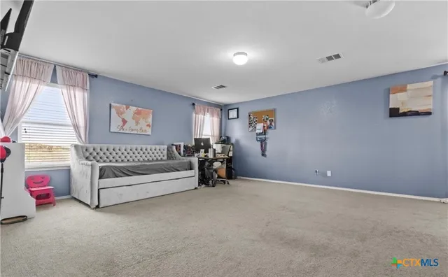 a spacious bedroom with a bed and a window