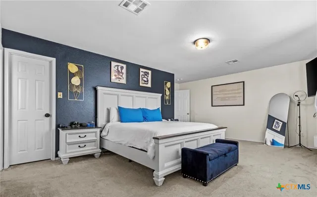 a bedroom with a bed and a night stand